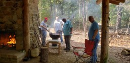 Men grilling hamburgers and hot dogs